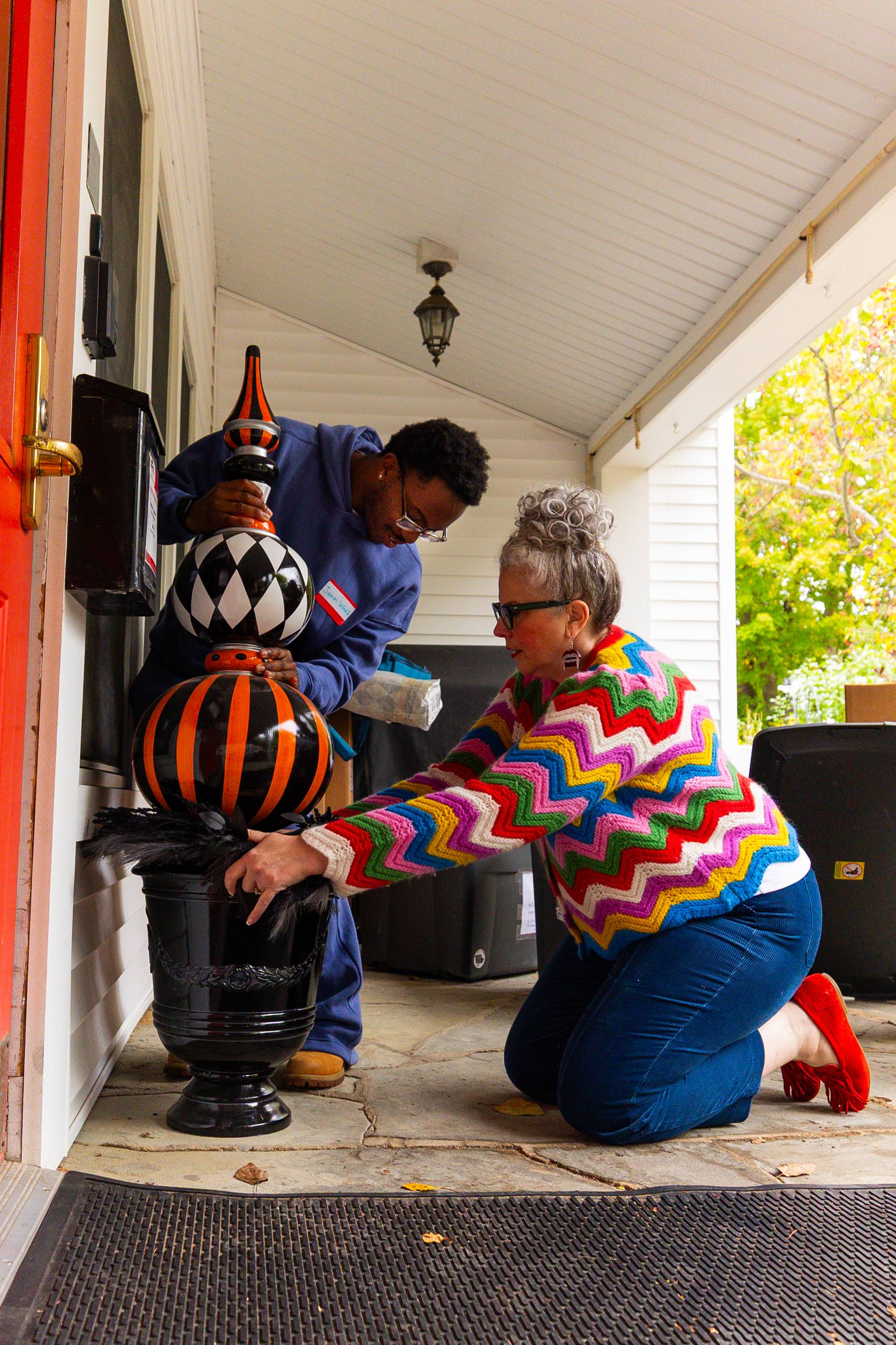man and woman fixing statue